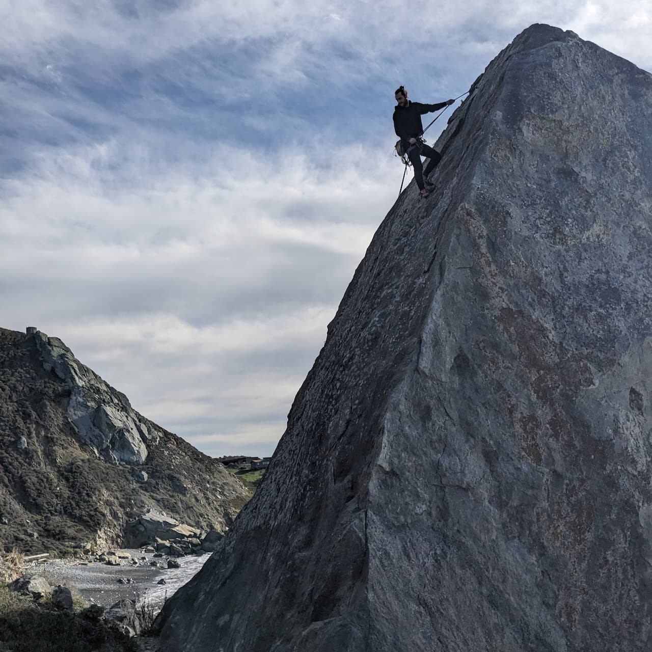 A photo of me rappelling down a slab climb on The Egg near Mickey's Beach.